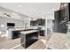 Spacious kitchen with large island, dark cabinetry, stainless steel appliances, and open floor plan at 23233 Banbury Way # 302, Venice, FL 34293