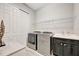 Laundry room with a laundry sink and modern washer and dryer units at 23233 Banbury Way # 302, Venice, FL 34293