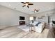 Spacious living room with a comfortable white sectional and easy access to the kitchen at 23233 Banbury Way # 302, Venice, FL 34293