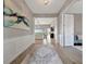 Foyer looking into the bright living room with white molding and wood floors at 23233 Banbury Way # 302, Venice, FL 34293