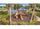 Outdoor playground area with slides and climbing structures, perfect for Gathering fun by the lake at 23233 Banbury Way # 302, Venice, FL 34293