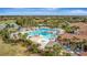 Resort-style pool area with multiple pools, lounge chairs, palm trees, and a nearby clubhouse at 23233 Banbury Way # 302, Venice, FL 34293