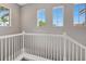 Staircase landing featuring multiple windows that offer views of tropical landscaping at 23233 Banbury Way # 302, Venice, FL 34293