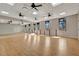 Spacious studio with hardwood floors, mirrored wall, and plenty of natural light from large windows at 23233 Banbury Way # 302, Venice, FL 34293