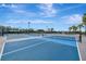 Outdoor tennis courts with well maintained court surface, nets, and manicured landscaping at 23233 Banbury Way # 302, Venice, FL 34293
