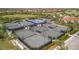 Multiple tennis courts surrounded by palm trees and lush landscaping in a private community at 23233 Banbury Way # 302, Venice, FL 34293