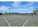 Outdoor tennis courts with well maintained court surface, nets, and manicured landscaping at 23233 Banbury Way # 302, Venice, FL 34293