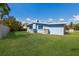 Spacious backyard with healthy green grass surrounding the house at 237 85Th St, Holmes Beach, FL 34217