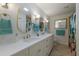 Bright bathroom boasts double sinks, granite countertop, and updated lighting at 237 85Th St, Holmes Beach, FL 34217