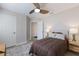 This bedroom features a ceiling fan, a comfy bed with a brown quilt, and natural light from the windows at 237 85Th St, Holmes Beach, FL 34217