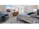 Comfortable bedroom showcases a cozy recliner chair, dresser, and bed, complemented by natural light from the windows at 237 85Th St, Holmes Beach, FL 34217