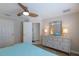 This bedroom features a light dresser with a mirror and lamps, complemented by views into the bathroom at 237 85Th St, Holmes Beach, FL 34217