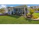 Quaint coastal home offering a manicured lawn, lovely front landscaping, and a cozy screened porch at 237 85Th St, Holmes Beach, FL 34217