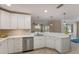 Stylish kitchen boasts stainless steel appliances, recessed lighting and quartz countertops at 237 85Th St, Holmes Beach, FL 34217