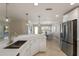 Modern kitchen features stainless steel appliances, bright lighting, and adjacent dining area at 237 85Th St, Holmes Beach, FL 34217