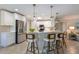 Bright kitchen featuring stainless steel appliances, a breakfast bar with seating, and modern pendant lighting at 237 85Th St, Holmes Beach, FL 34217