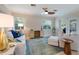 Inviting living room with ceiling fan, sliding glass door, and comfortable seating at 237 85Th St, Holmes Beach, FL 34217