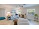 Cozy living room with neutral-toned furniture, natural light, and ceiling fan at 237 85Th St, Holmes Beach, FL 34217