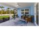 Cozy screened patio with comfortable seating and stylish rug, perfect for outdoor relaxation at 237 85Th St, Holmes Beach, FL 34217