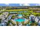 Aerial view of resort-style pools, tennis courts, lush landscaping, and community buildings at 2578 Wild Cherry Path, Sarasota, FL 34240