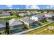 Aerial view showcasing backyard pools, screened enclosures, and pristine white fences in a residential neighborhood at 2578 Wild Cherry Path, Sarasota, FL 34240