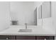 A well-lit bathroom has a white countertop with brown cabinets and chrome fixtures at 2578 Wild Cherry Path, Sarasota, FL 34240