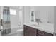 Bathroom featuring a shower-tub combo, modern vanity with a white countertop, and white tiles at 2578 Wild Cherry Path, Sarasota, FL 34240