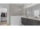 Modern bathroom features a double sink vanity with granite counters and a tiled walk-in shower at 2578 Wild Cherry Path, Sarasota, FL 34240