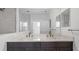 Elegant bathroom with double sinks, modern fixtures, and a large mirror at 2578 Wild Cherry Path, Sarasota, FL 34240