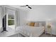 This bright bedroom boasts neutral colors and a ceiling fan at 2578 Wild Cherry Path, Sarasota, FL 34240