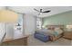 A beautifully decorated bedroom offers a cozy bench and ample natural light at 2578 Wild Cherry Path, Sarasota, FL 34240