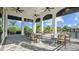 Covered patio with tables and chairs, providing a relaxing outdoor space for dining and socializing in the community at 2578 Wild Cherry Path, Sarasota, FL 34240