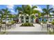 Exterior of the clubhouse showcasing outdoor seating, vibrant landscaping, and a welcoming entrance at 2578 Wild Cherry Path, Sarasota, FL 34240