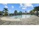 Large community pool with splash pad, lounge chairs, and palm trees, creating a resort-style atmosphere for residents at 2578 Wild Cherry Path, Sarasota, FL 34240