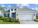 Beautiful single Gathering home with a neutral exterior and inviting curb appeal at 2578 Wild Cherry Path, Sarasota, FL 34240