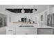 An open concept gourmet kitchen boasts a large island, stainless steel appliances, and pendant lighting at 2578 Wild Cherry Path, Sarasota, FL 34240