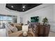 Inviting living room featuring a comfortable seating area, modern decor, and a view of the outdoor pool at 2578 Wild Cherry Path, Sarasota, FL 34240