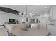 Open-concept living space with a kitchen island, dining area, and living room, perfect for entertaining at 2578 Wild Cherry Path, Sarasota, FL 34240