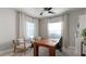 Bright home office featuring neutral walls, two large windows, and comfortable furniture at 2578 Wild Cherry Path, Sarasota, FL 34240