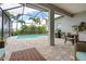 Expansive screened patio showcasing a private pool, outdoor seating, and a built-in grill for entertaining and relaxing at 2578 Wild Cherry Path, Sarasota, FL 34240