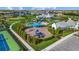 Aerial view of a community playground, pool, clubhouse, and other recreational areas, surrounded by lush landscaping at 2578 Wild Cherry Path, Sarasota, FL 34240