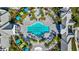 Overhead shot of a pristine rectangular pool surrounded by lounge chairs, umbrellas, and lush greenery at 2578 Wild Cherry Path, Sarasota, FL 34240