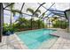 A serene private pool surrounded by tropical landscaping and a screened enclosure, perfect for relaxation and recreation at 2578 Wild Cherry Path, Sarasota, FL 34240