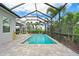 Screened in pool and patio with tropical landscaping offering a private backyard oasis at 2578 Wild Cherry Path, Sarasota, FL 34240