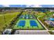Aerial view of tennis courts, a walking path, and community landscaping, offering recreational amenities at 2578 Wild Cherry Path, Sarasota, FL 34240