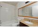 Clean bathroom with a shower-tub combo and a wood-framed mirror at 2704 Hidden Lake Blvd # C, Sarasota, FL 34237