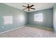 Bedroom featuring a ceiling fan, light-colored tile floors and a window for natural light at 2704 Hidden Lake Blvd # C, Sarasota, FL 34237