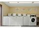 Laundry room featuring multiple clean washing machines at 2704 Hidden Lake Blvd # C, Sarasota, FL 34237