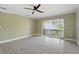 Bright, spacious living room with tile floors and sliding glass doors to the balcony at 2704 Hidden Lake Blvd # C, Sarasota, FL 34237