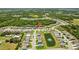 This aerial view highlights the community, nearby lakes, and surrounding lush greenery at 2721 Greenleaf Ter, Parrish, FL 34219